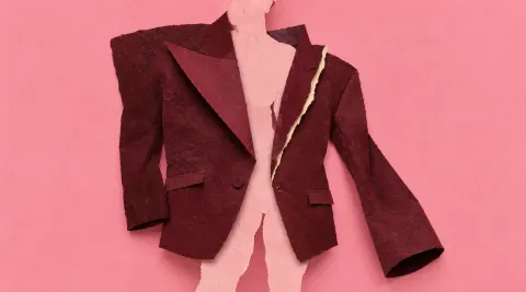 An oversized burgundy paper dinner jacket hangs around an irregular pink silhouette, with a pale torn seam revealing the mismatch.